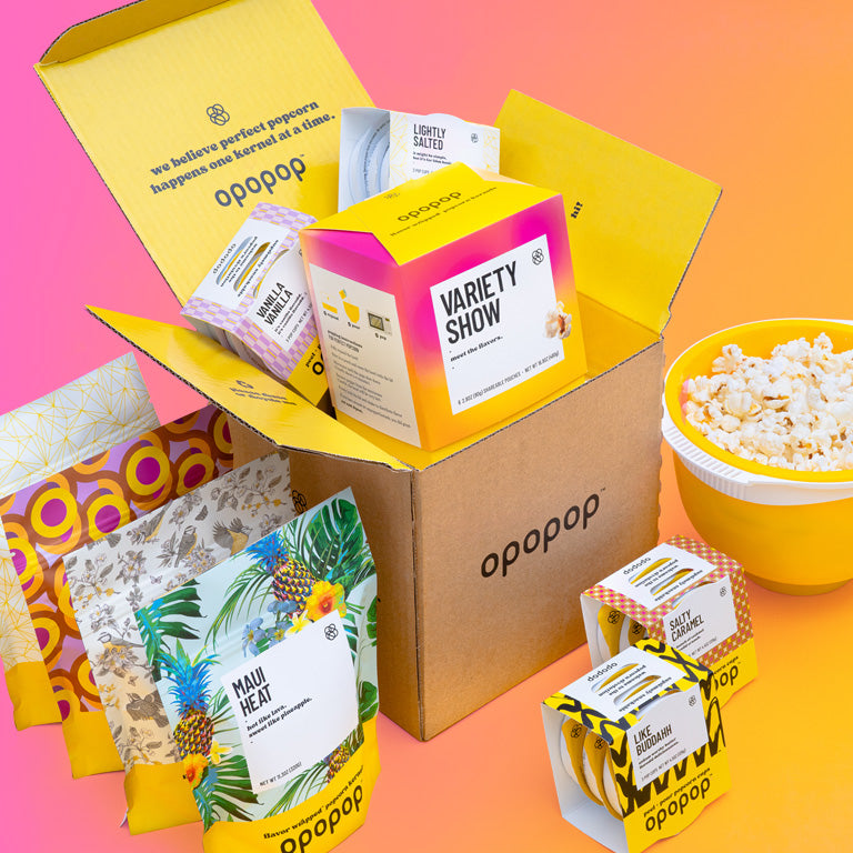 Image of a large box full of Opopop popcorn. Introducing Kernel Club our Free Shipping Membership